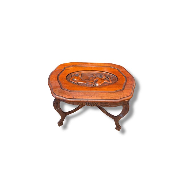 Beautiful vintage carved wood side table featuring an ornate relief of flowing mermaid figures across the tabletop. Rich...