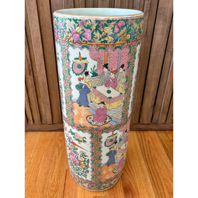 An over-sized 24" umbrella stand of the Chinese 'Rose Canton' style. Hand-painted with peacocks, butterflies, a ceremonial...