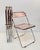 Set of 4 original and signed "plia" pink acrylic glass folding chairs. This fantastic set was designed by giancarlo...