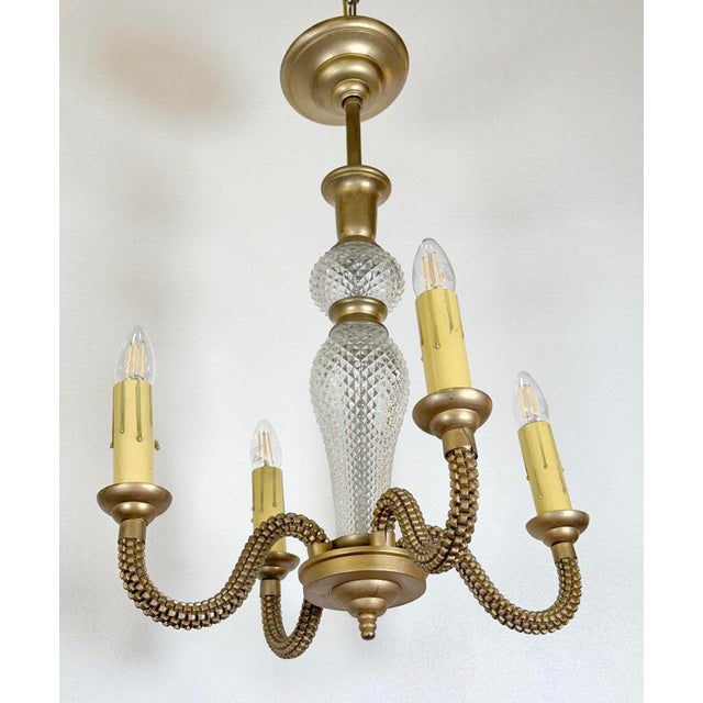 French Art Deco chandelier made around 1935-1940. It is made of brass, with heavily textured arms and diamond cut textured...