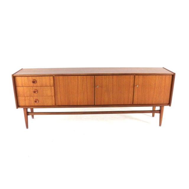 This exceptionally beautiful sideboard is a rare and timeless piece of furniture that dates directly from the golden age...