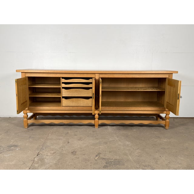 This oak sideboard was designed by Henning Kjærnulf and produced by Nyrup Møbelfabrik in Denmark during the 1960s. Four...