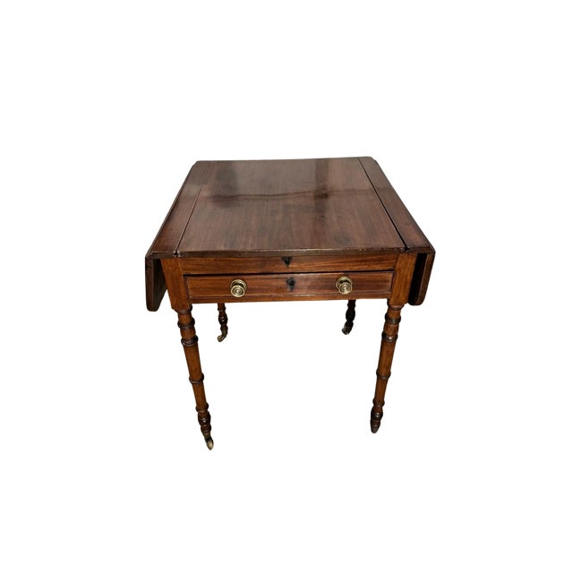 A refined English Regency period mahogany games table featuring a beautifully inlaid chessboard to the top and fitted...