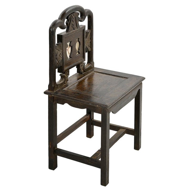 This sculptural chair is a magnificent specimen of craftsmanship, whose design pays homage to traditional art. with a...