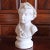 A marble sculpture of a girl inspired by antique classical sculptures of the goddess Ceres, the Roman goddess of wheat and...