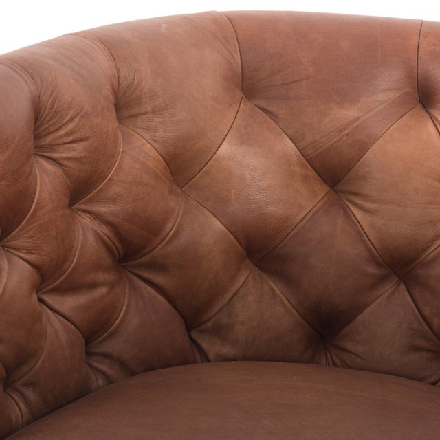 A perfectly curved statement on a 360 swivel. Soft heirloom top-grain leather is pristinely tailored, with dramatic blind...