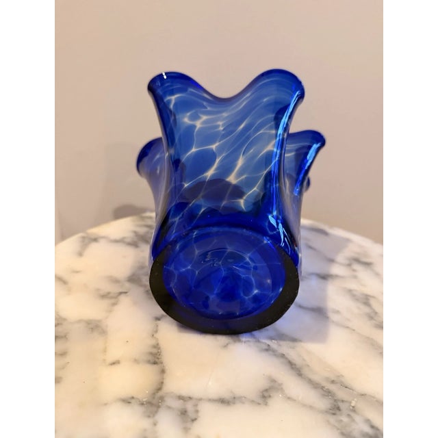 Add a bold pop of color with this stunning vintage cobalt blue hand-blown art glass vase. Featuring a graceful swirl...