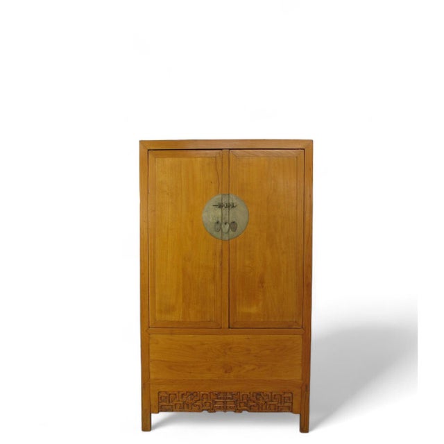This antique Chinese armoire cabinet exudes refinement and grace with its straight lines, elegant design, and rubbed...