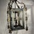 Gold gilt accented Patinated European iron hanging lantern with heavy Acanthus scrolled designs, the center panels with...