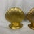 This is a pair of vintage solid brass clam seashell bookends featuring a classic fluted design and polished golden finish.