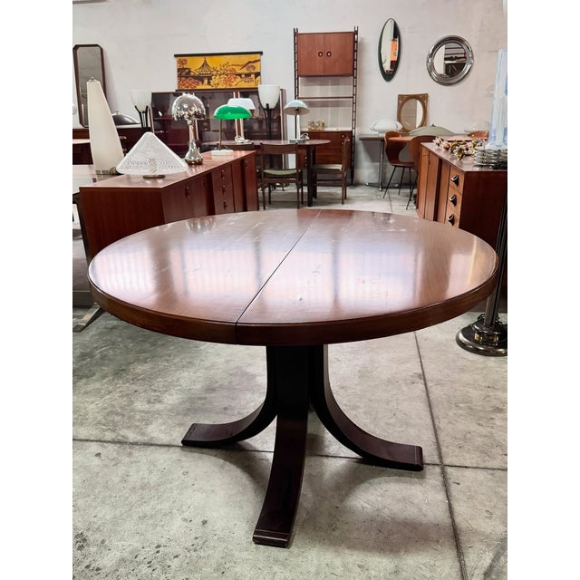 Extendable dining table made in Italy, featuring clean, balanced lines typical of mid-century design from the 1970s. The...