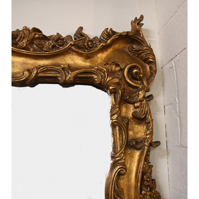 Magnificent Regency style giltwood overmantel mirror, of impressive scale and richly carved form, with a superbly...