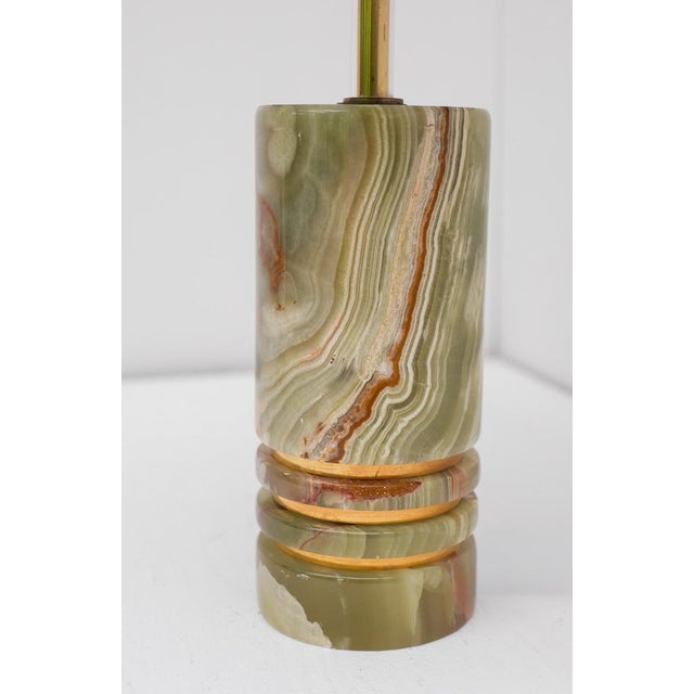 An Italian table lamp crated onyx and brass “Pierre Veritable” from the 1960s. This elegant lamp embody the sophisticated...