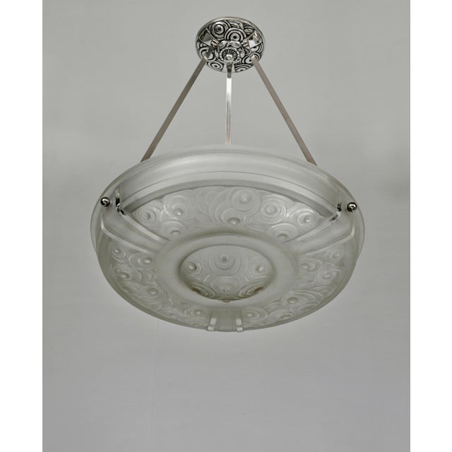Marius Sabino A rare French 1930 art deco chandelier in nickel plated solid brass or bronze holding a signed bowl by...