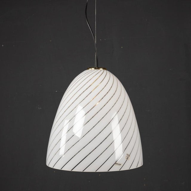 Mid 20th Century Italian Murano glass swirl bowl shade pendant light with brass fittings. This light was created in the...