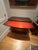 This is a mahogany bowfront chest of drawers with a pull out writing shelf. A glass top covers the surface. There are...