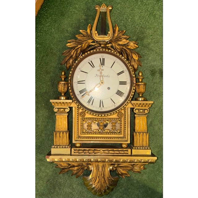 This listing is for a large Swedish wall clock. This clock was made in the Gustavian style with a gilt wood cartel frame....