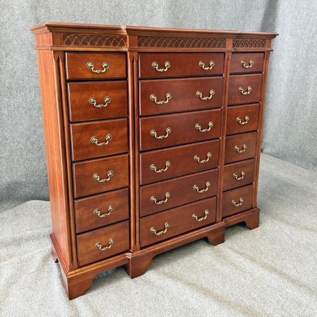 This monumental Lane cherry chest of drawers features a commanding, symmetrical façade with an abundance of storage, warm...