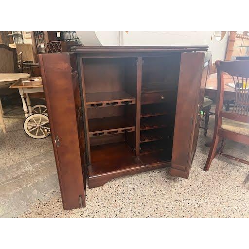 This traditional-style cabinet is designed for versatility, featuring an expandable top that slides open to provide a...