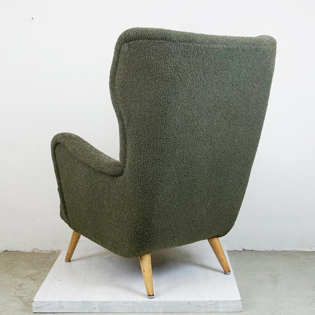 This Mid century Modern highly comfortable Wingback armchair has been designed and manufactured in Vienna Austria 1950s....