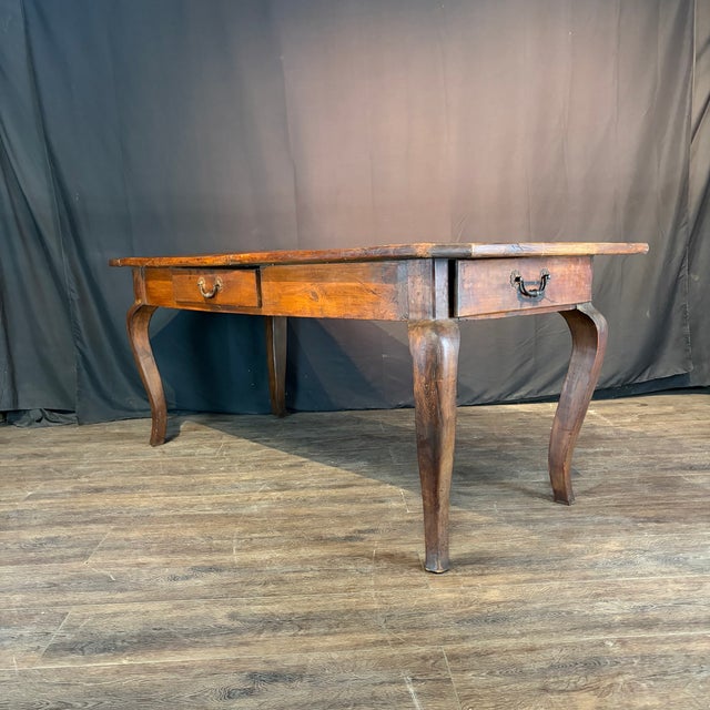 Classic handsome early 19th century French dining table with a broad rectangular plank top, two generous drawers and...