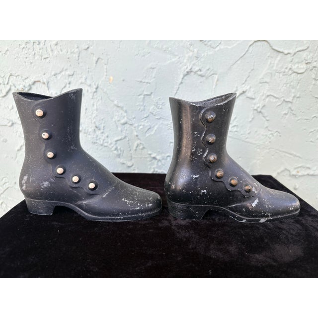 This charming pair of antique lady’s boots is crafted entirely in cast metal, most likely cast iron, and dates to the late...