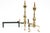 A pair of Georgian style polished brass andirons with tall urn-form, ball-topped finials, twisted central sphere, shell-...
