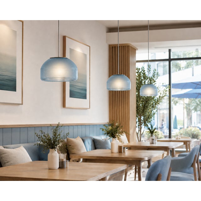 Crafted with high visual clarity, this modern pendant lamp features a sleek silhouette hand-blown from premium glass in a...