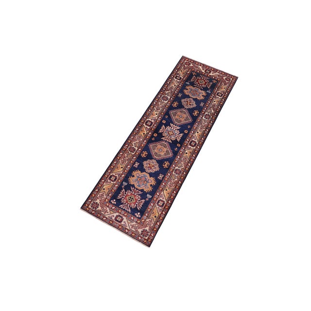 Enhance your home with this exquisite hand-knotted Super Kazak rug, crafted from fine hand-spun wool and dyed with all-...