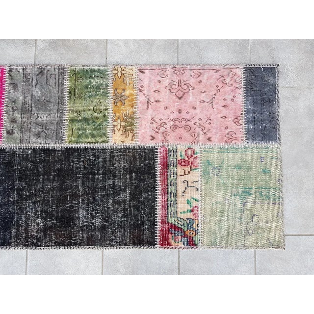 This is a vintage Turkish Oushak rug from the Mid 20th Century. The piece was hand-knotted.