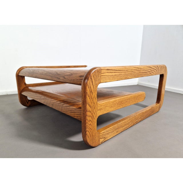 Supercool mid-century modern coffee table by Lou Hodges in oak and with a smoked glass top. It has a handy magazine tray...
