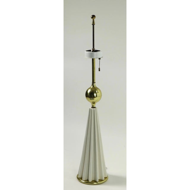 Stylish architectural table lamp designed by Gerald Thurston. The lamp has a white ribbed conical base with a brass...