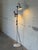 This adjustable metal floor lamp delivers targeted task lighting with two directional cone shades. Built with a slender...