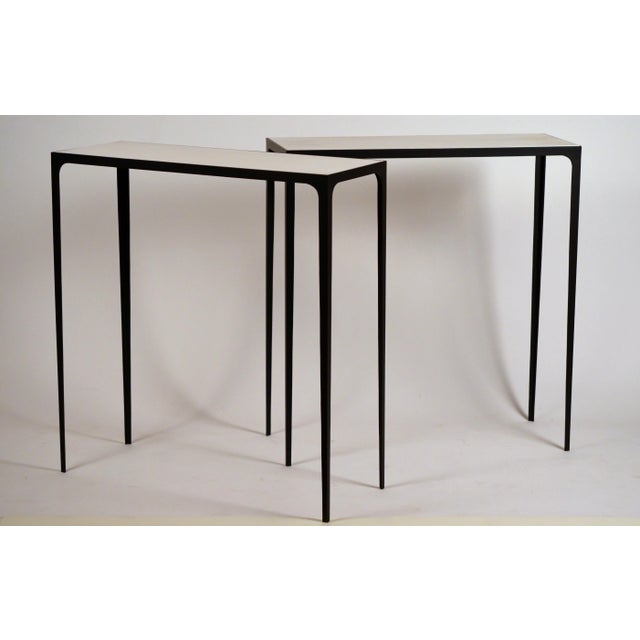 Pair of chic 'Esquisse' wrought iron and parchment consoles by Design Frères. Contrasting white/cream goat parchment top...