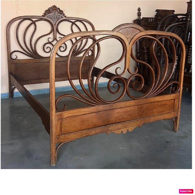Designed by j & j kohn, this mahogany stained bentwood bed features curved head and footboards swelling with decorative...