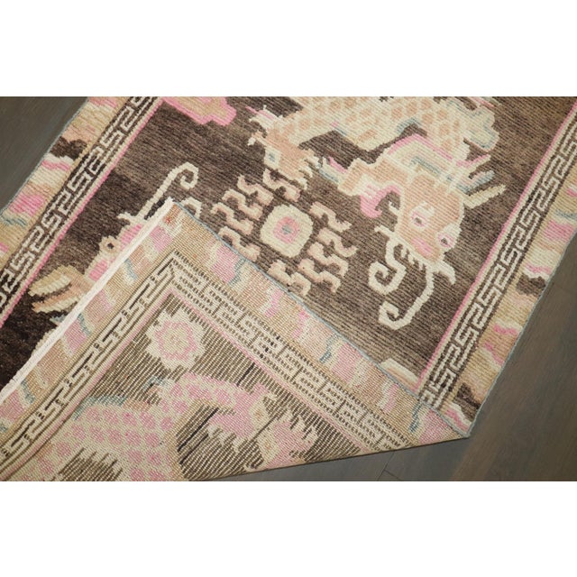 A 2nd quarter of the 20th-century feminine colored Tibetan rug with a dragon motif on a brown color field. Size: 3'1'' x...