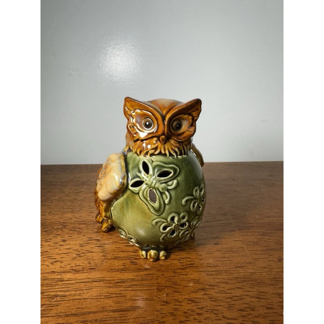 Vintage ceramic owl figurine featuring a green and brown glazed finish with pierced floral cutouts. Hollow pottery design...
