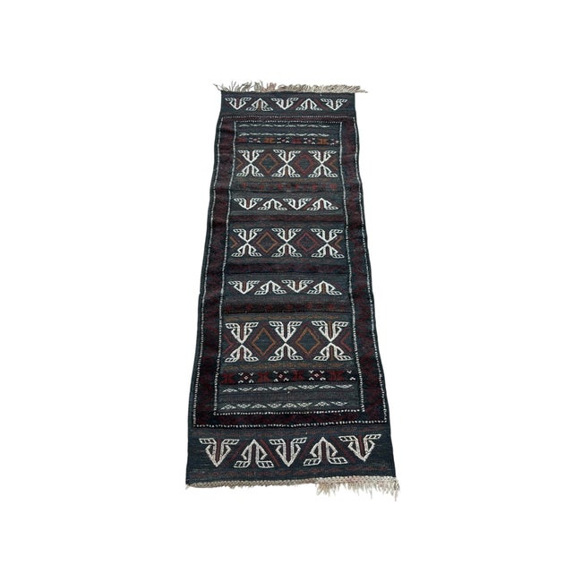 Afghan Turkmen rug, hand-knotted in Afghanistan from 100% wool. Measuring 2'1" W x 5'6" H, the rug features a rich...