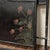 Vintage king-size metal bed frame with hand-painted floral details in an ebonized black finish. The headboard and...