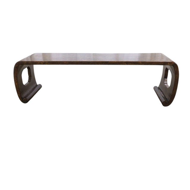 A chinoiserie style waterfall shaped coffee table, beautifully finished in a rich chocolate brown lacquer with gilt...