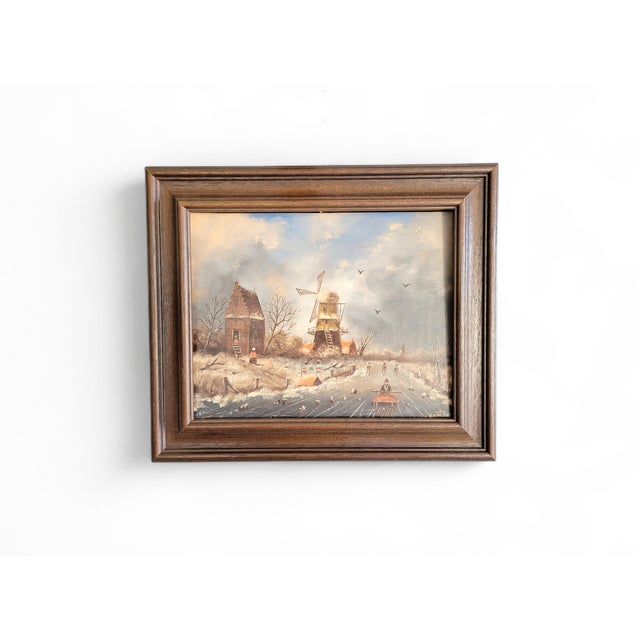 A charming and romantic vintage Dutch winter landscape painting, executed in oil on board and presented in its wooden...