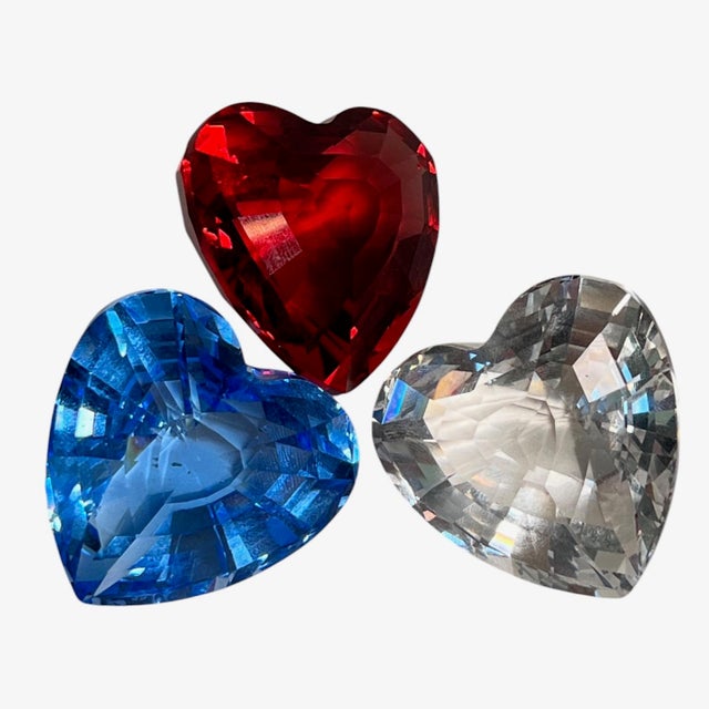 Trio of collectible Swarovski faceted crystal hearts, in transparent, saphire blue and ruby red with maker's mark on each.