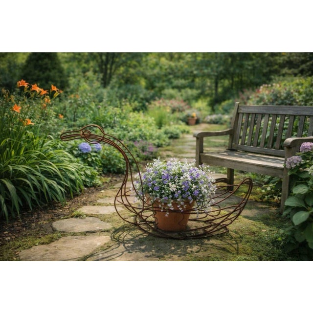 A large vintage wire swan planter crafted from rustic metal, measuring an impressive 45 inches in length and offering...