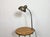 Industrial flexible gooseneck table lamp made in former Czechoslovakia during the 1960s. It features a green metal shade a...