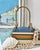 Vintage brass display stand featuring sculptural shell accents and an arched silhouette, offering a refined coastal...