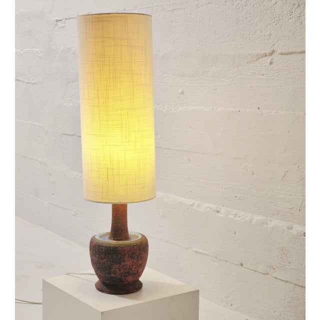 Mid century scandinavian ceramic pottery lamp, with glazed parts. A High neutral shade on top of the reddish brown base...