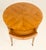 An elegant Neoclassical-style side table, attributed to Baker Furniture, distinguished by refined proportions, beautifully...
