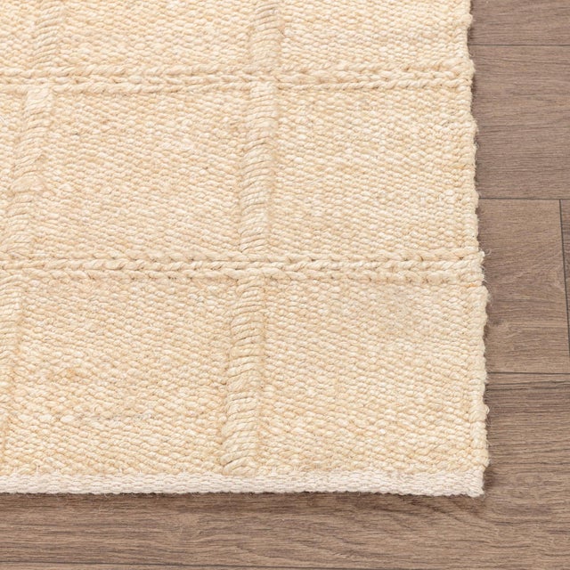 Woven jute rug in a fresh light sand color. Square lattice pattern adds subtle texture and dimension. Available in...