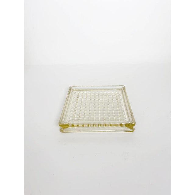 Iconic square glass ashtray inspired by the timeless design associated with Le Corbusier. Crafted in thick molded glass...