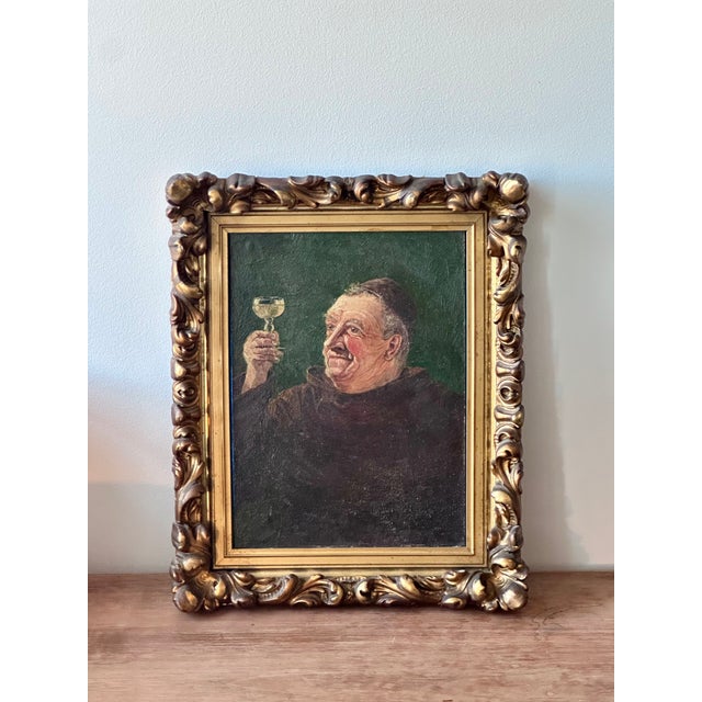 Expressive antique European genre painting depicting a jovial monk raising a glass of wine, rendered with warm tones,...